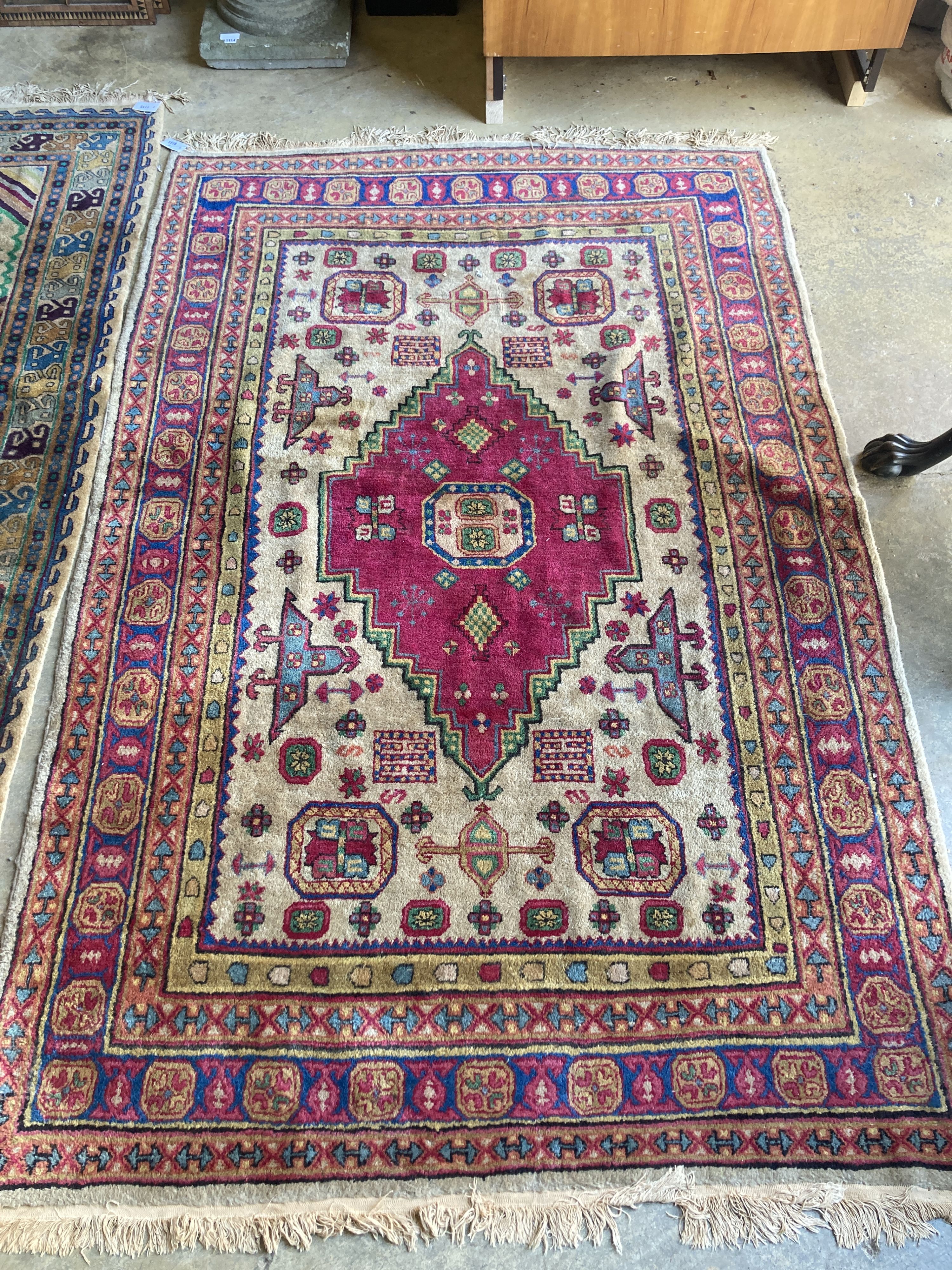 A Caucasian design fawn ground rug, 240 x 158cm